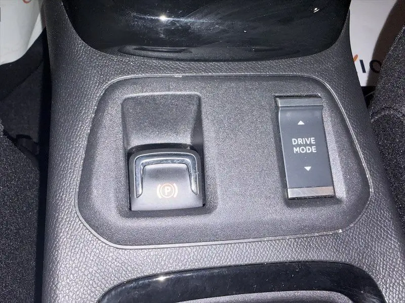 Gros plan sur la console centrale de l’Opel Corsa 2025 gris, montrant le bouton de frein à main électronique et le sélecteur Drive Mode.