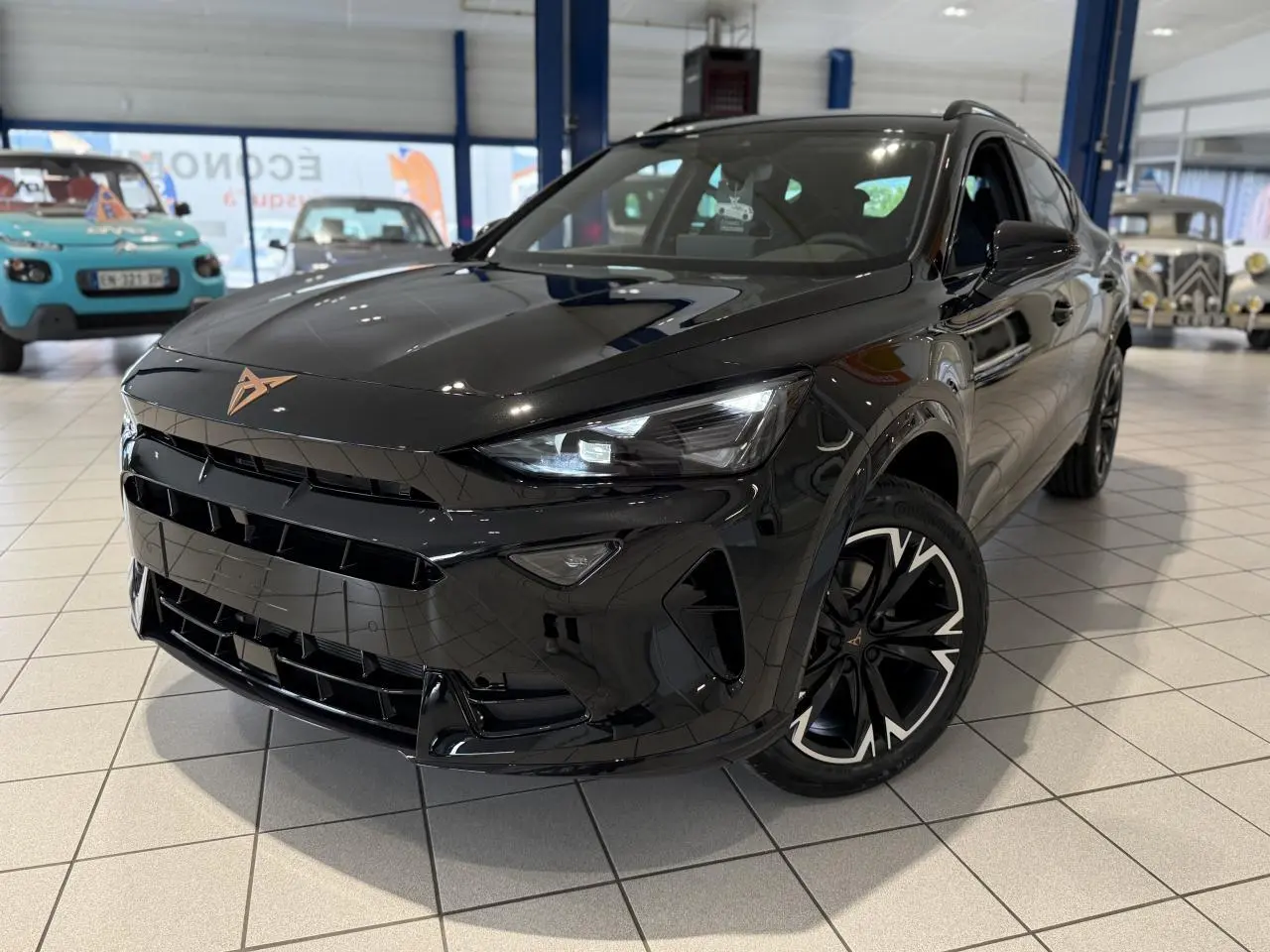 CUPRA Formentor noir Night en 3/4 avant droit, avec jantes alliage noires et logo cuivré sur calandre.