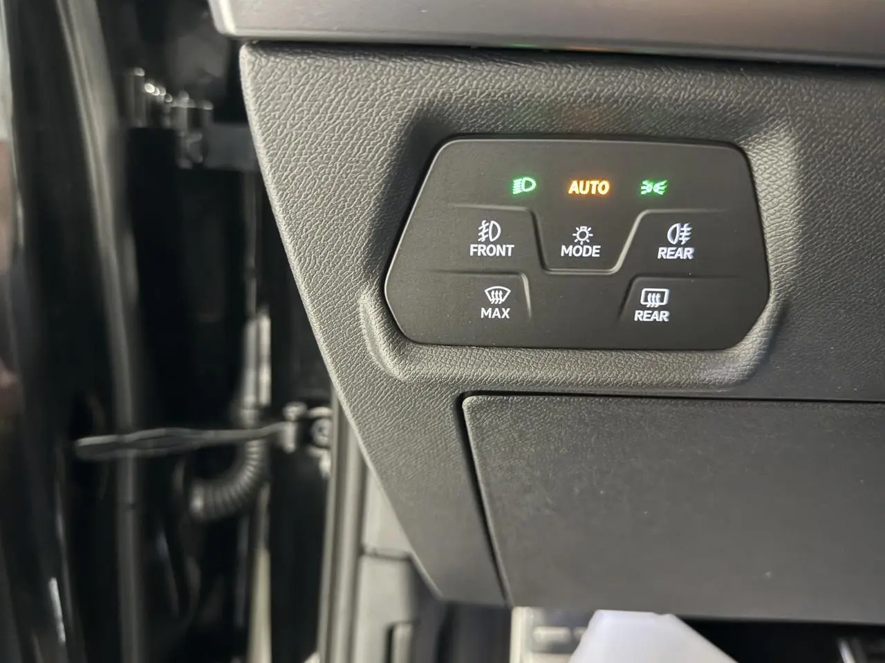 Panneau de commandes d’éclairage avec indicateurs verts et orange, côté gauche intérieur du CUPRA Formentor noir Night 2025.