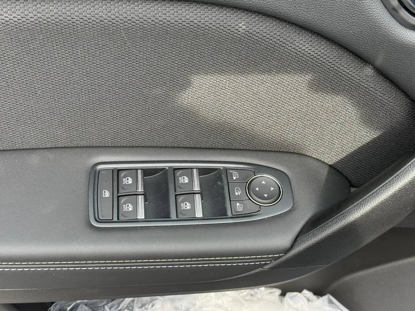 Panneau de commandes des vitres et rétroviseurs côté gauche en cuir noir avec surpiqûres blanches, Renault Symbioz 2026.