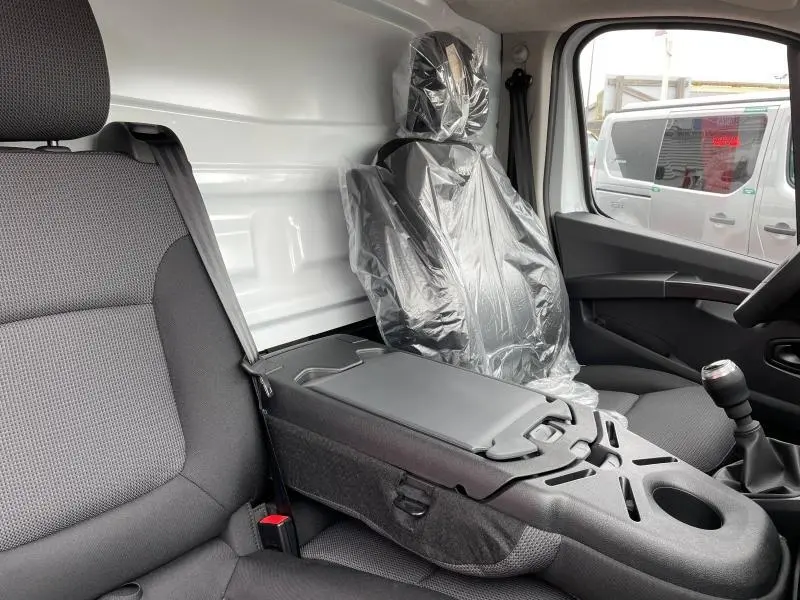 Intérieur du Renault Trafic Fourgon blanc, vue côté droit sur banquette passager avec bureau mobile et siège conducteur protégé.