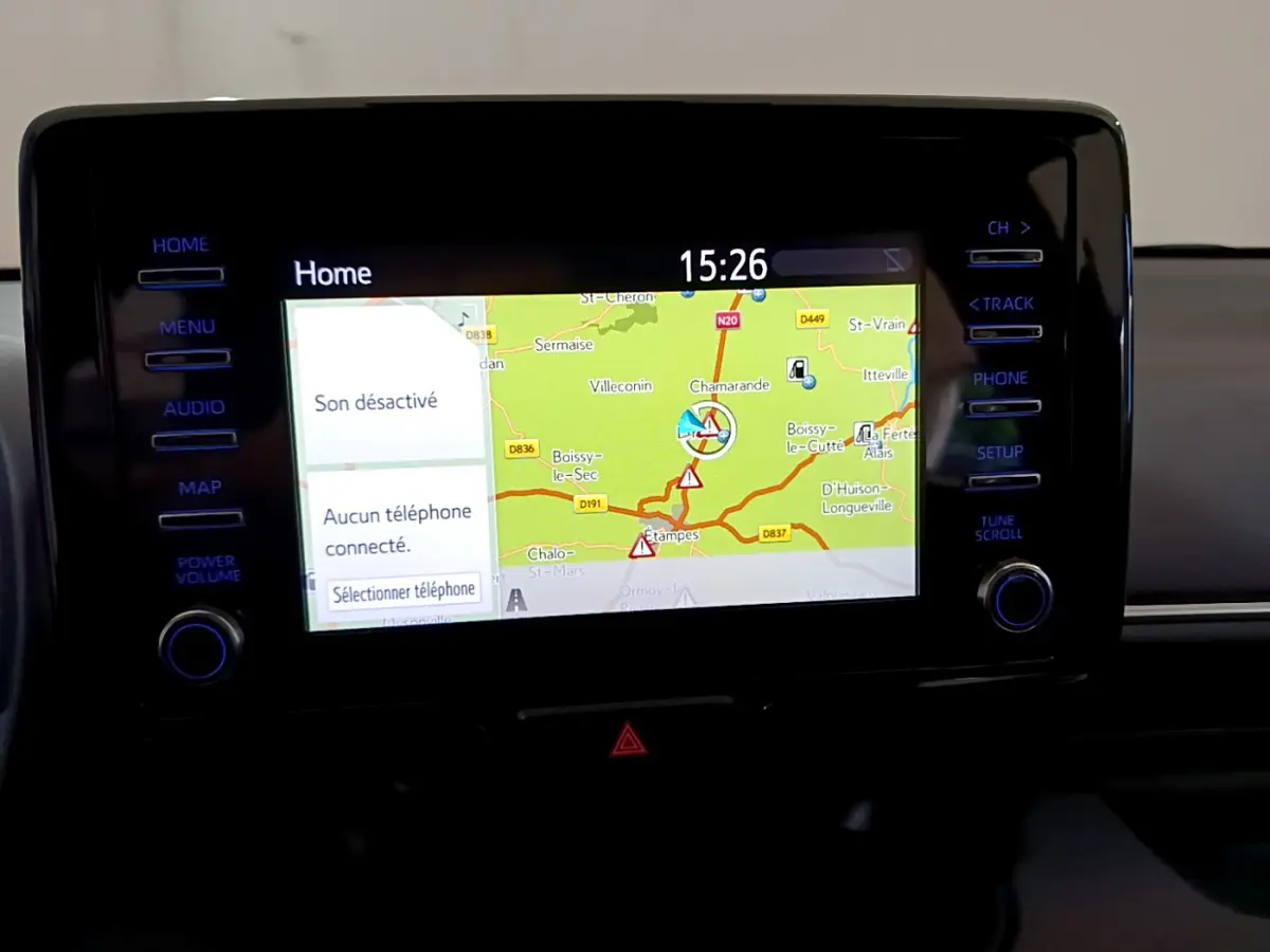 Écran tactile central de navigation de la Toyota Yaris hybride 2021 affichant une carte routière et les commandes latérales.