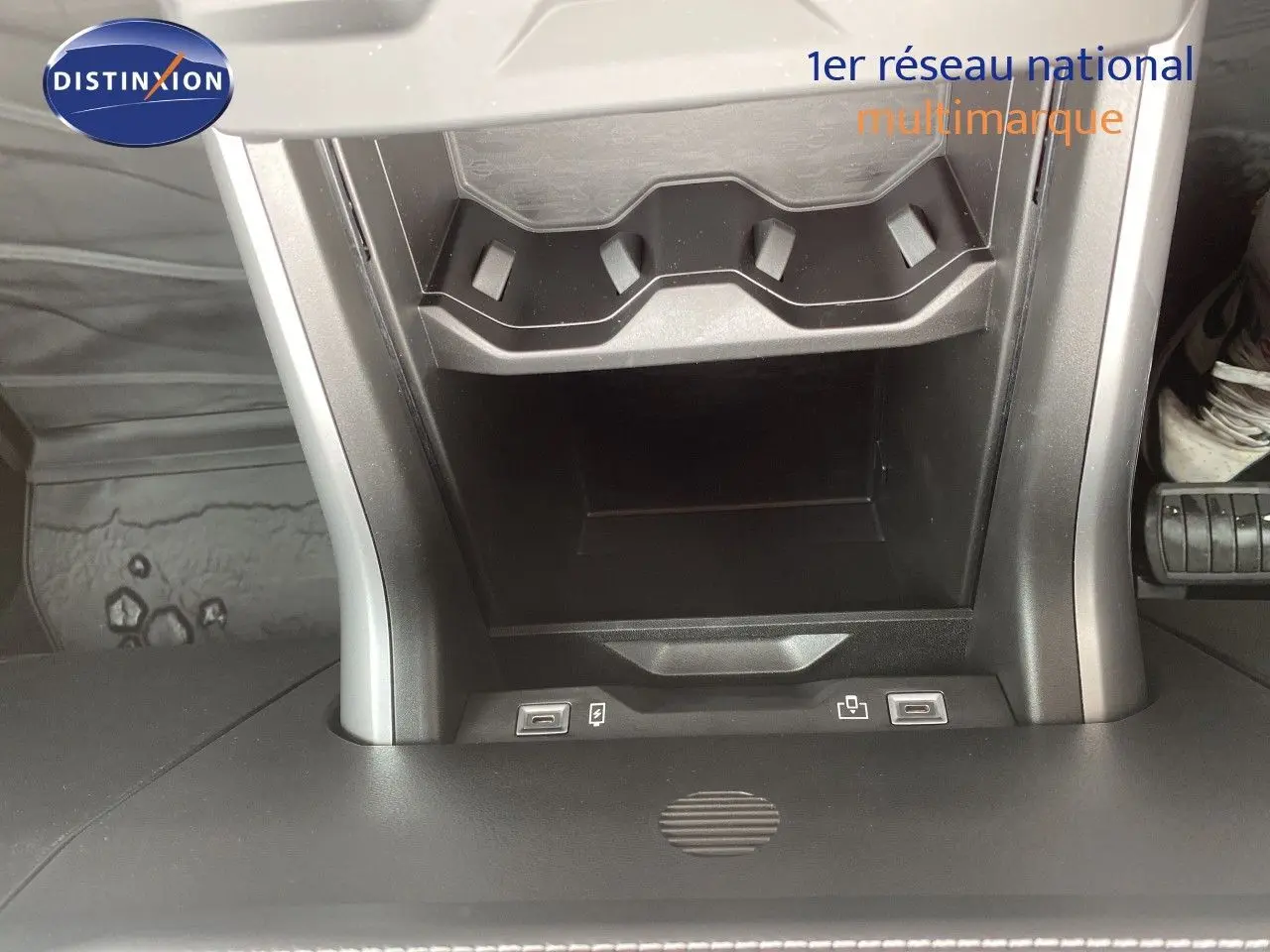 Vue rapprochée de la console centrale du Jeep Compass noir Vulcano, montrant les ports USB et un rangement intégré.