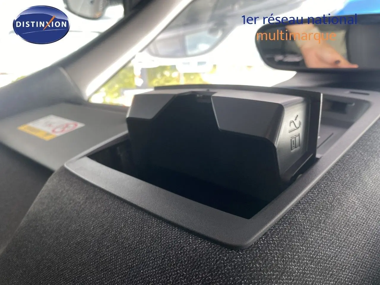 Détail intérieur du tableau de bord du Jeep Compass 2026 noir Vulcano, mettant en valeur un compartiment de rangement ouvert.