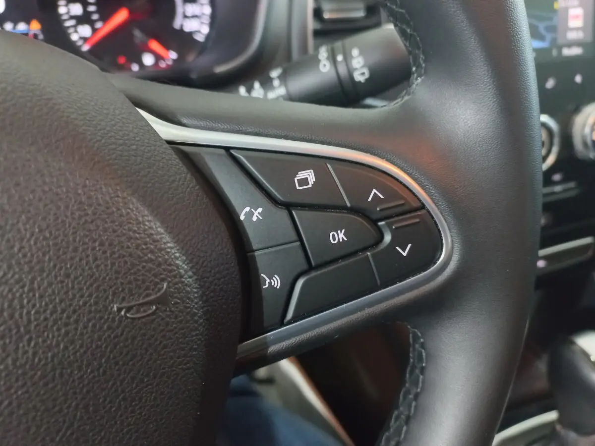 Gros plan sur les commandes multifonctions du volant noir de la Renault Mégane Business Blue dCi 115 EDC 2022.