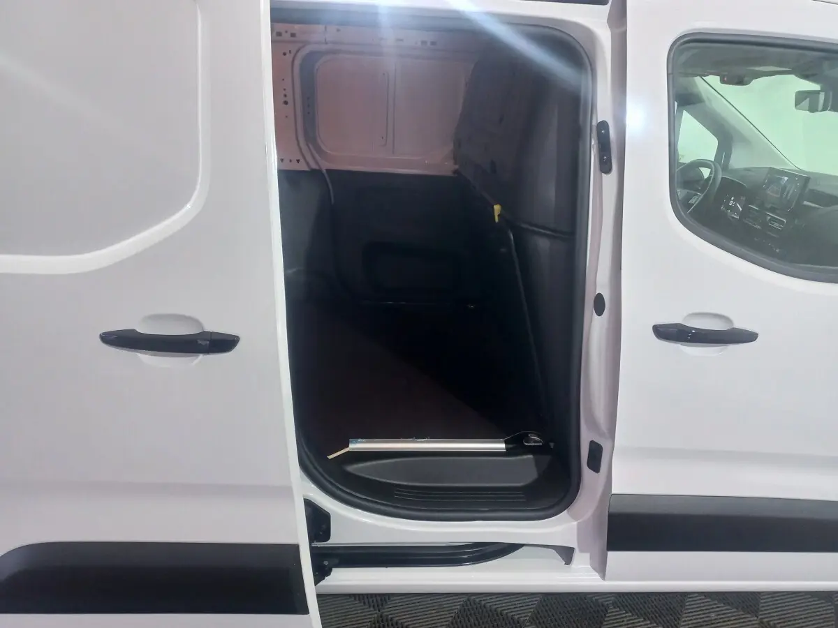 Vue latérale du Citroën Berlingo XL blanc 2025 avec porte coulissante ouverte montrant la cloison pleine intérieure.