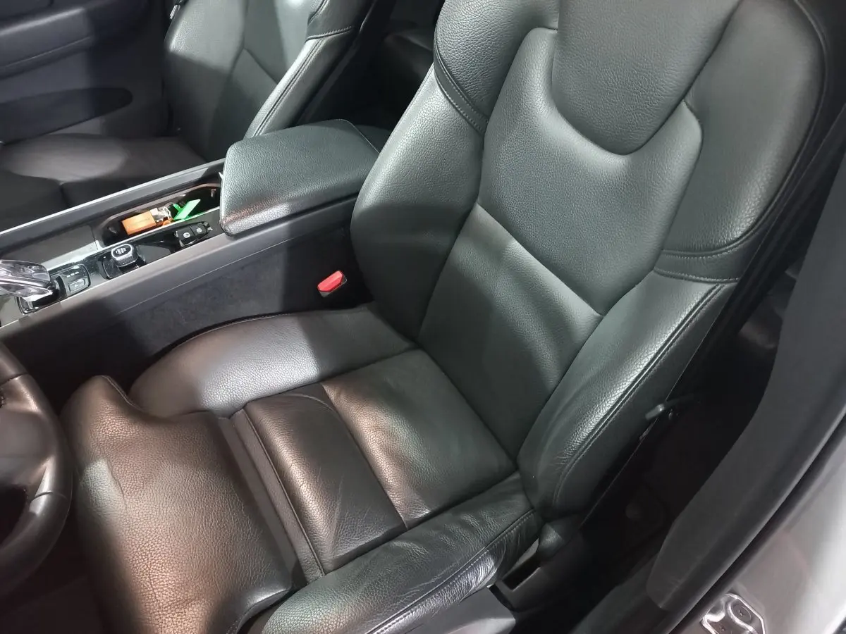 Gros plan sur siège conducteur en cuir noir et console centrale du Volvo XC60 B4 gris clair, version Inscription 2022.