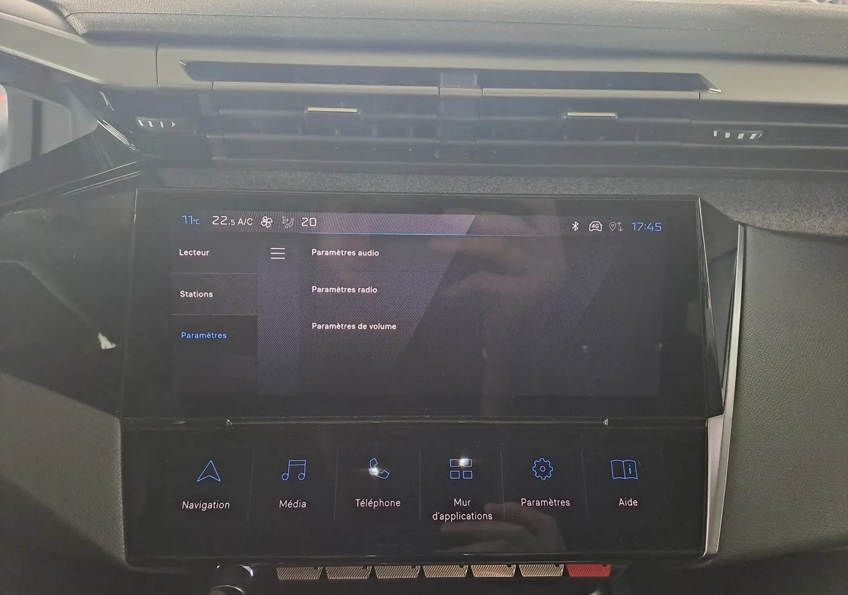 Écran tactile central de la Peugeot 308 2023 affichant les paramètres audio et radio dans un intérieur gris.