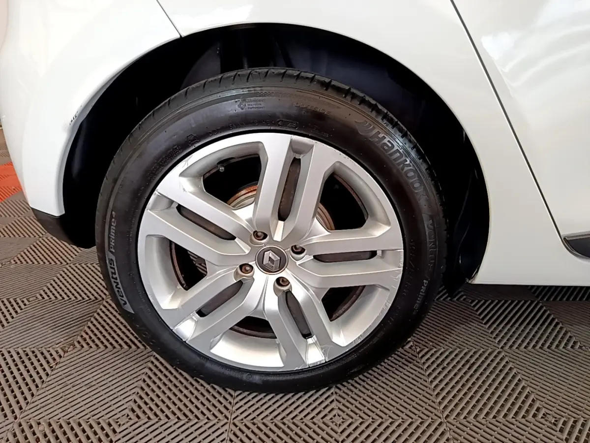 Gros plan sur la roue avant droite blanche d'une Renault Clio Business TCe 90 avec jante alliage à cinq branches.