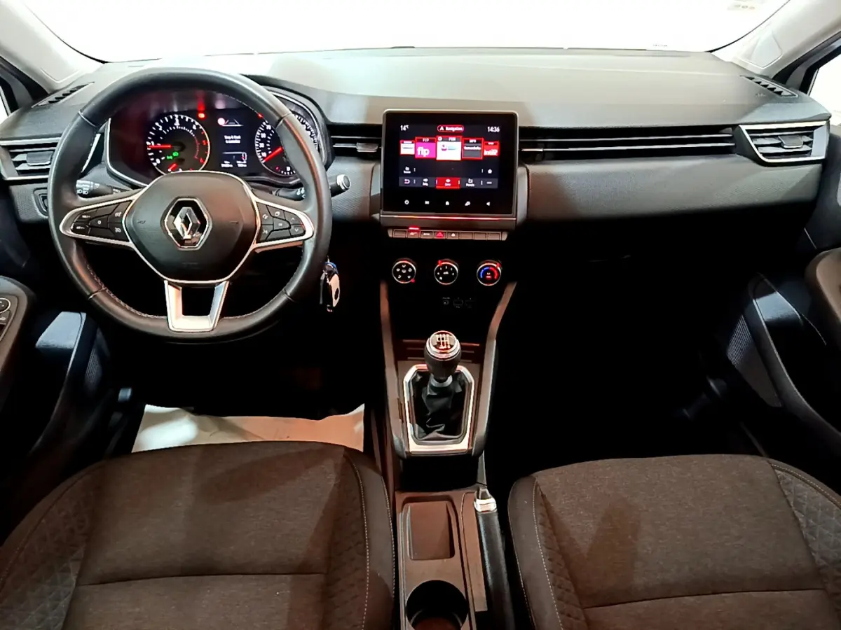 Vue intérieure frontale du tableau de bord et volant cuir noir de la Renault Clio Business Blue dCi 85 avec écran tactile central.