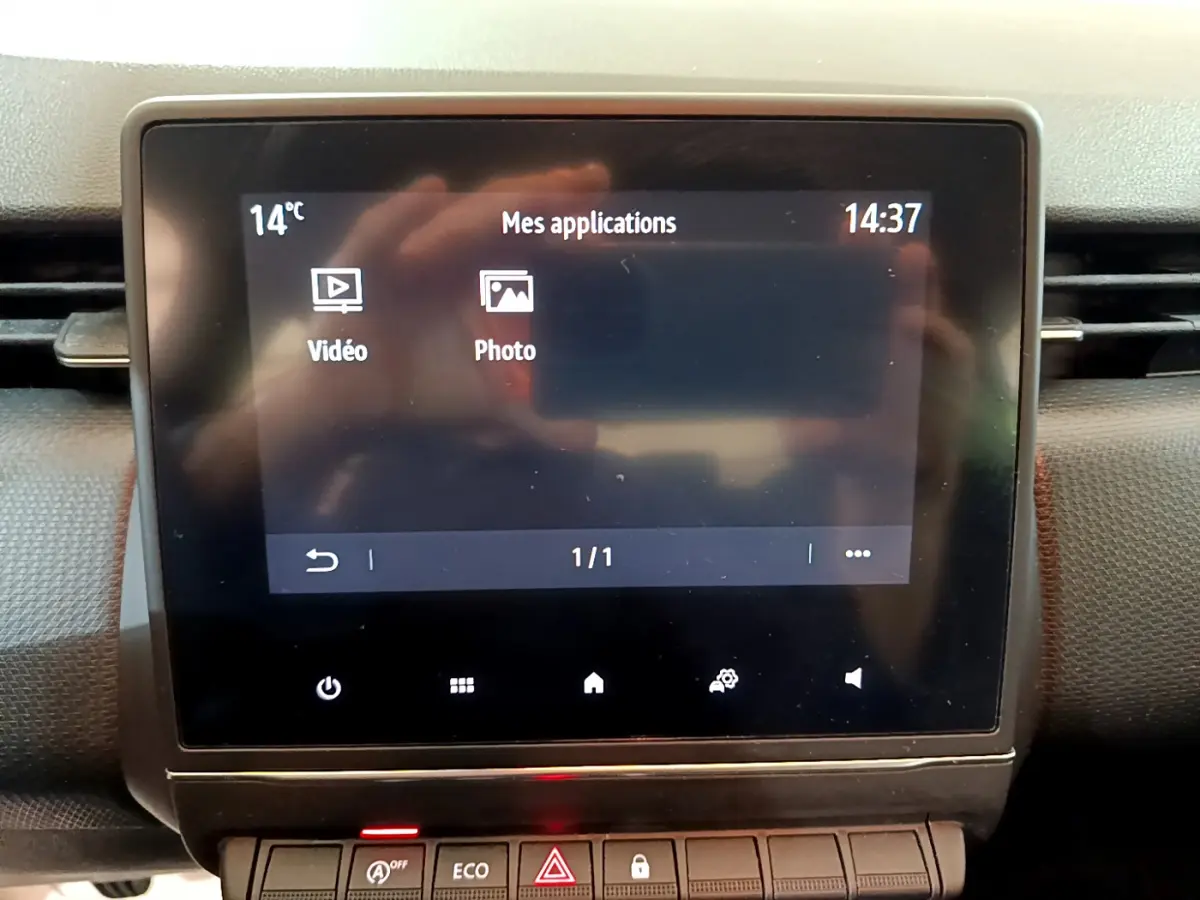 Écran tactile central affichant les applications vidéo et photo dans l'habitacle de la Renault Clio Business Blue dCi 85 blanche.