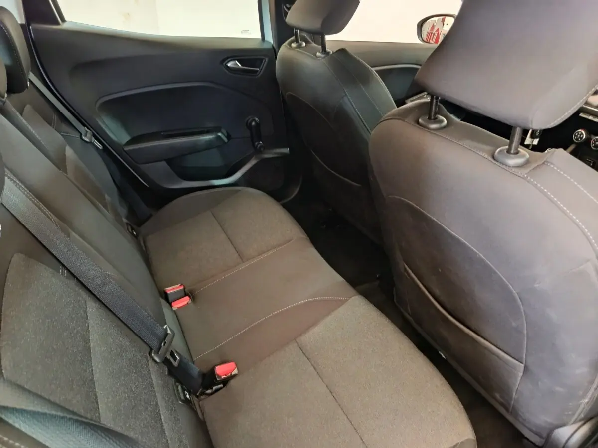 Vue intérieure arrière de la Renault Clio Business Blue dCi 100 2022, sièges tissu gris foncé avec ceintures de sécurité visibles.