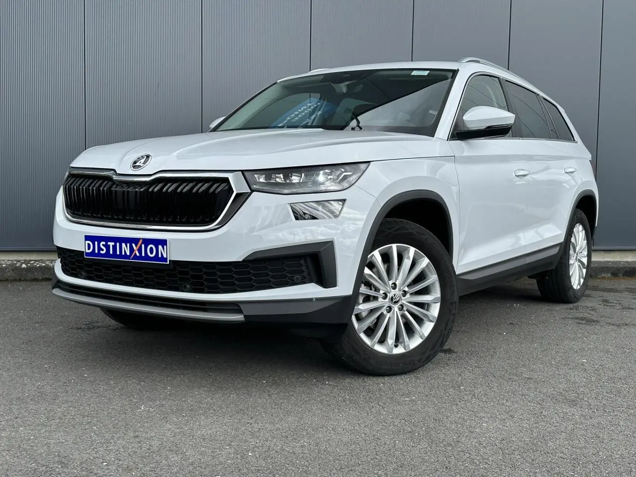 SUV Skoda Kodiaq blanc glacier en 3/4 avant droit, avec calandre noire et jantes alliage 18 pouces ELBRUS.