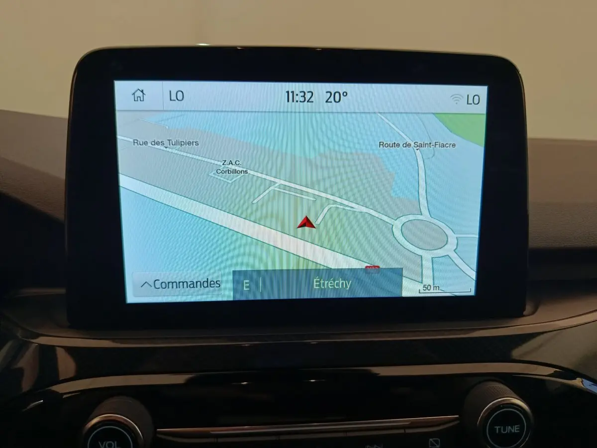Écran tactile central affichant la navigation GPS du Ford Kuga 2024, vue intérieure du tableau de bord noir.