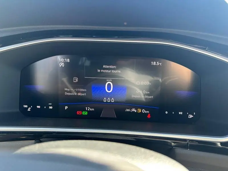 Vue rapprochée du tableau de bord numérique du Volkswagen T-Roc 2025 affichant la vitesse à 0 km/h et diverses alertes.