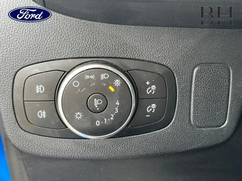 Gros plan sur la commande des phares du Ford Puma 2022 en Fashion Bleu Island Métallisée, avec réglages éclairage visibles.