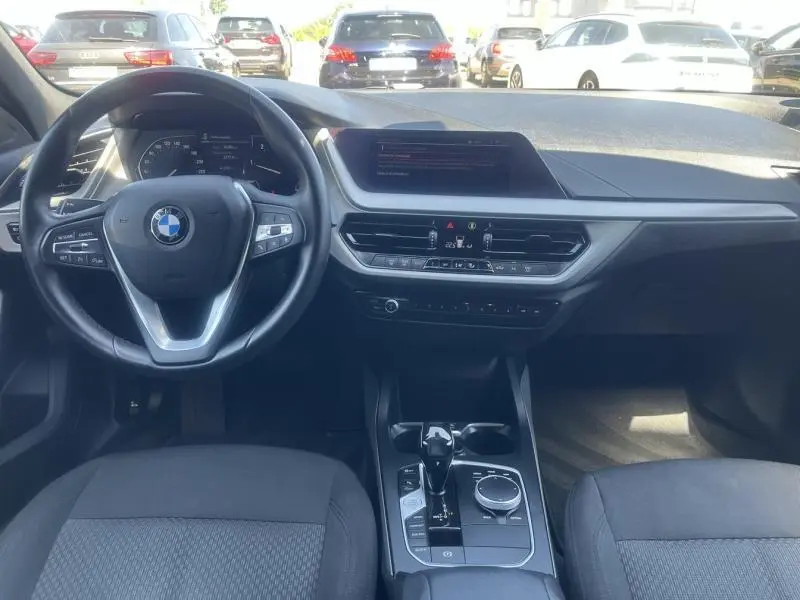 Vue intérieure avant de la BMW Série 1 116dA 2020 avec tableau de bord moderne et volant cuir multifonction noir.