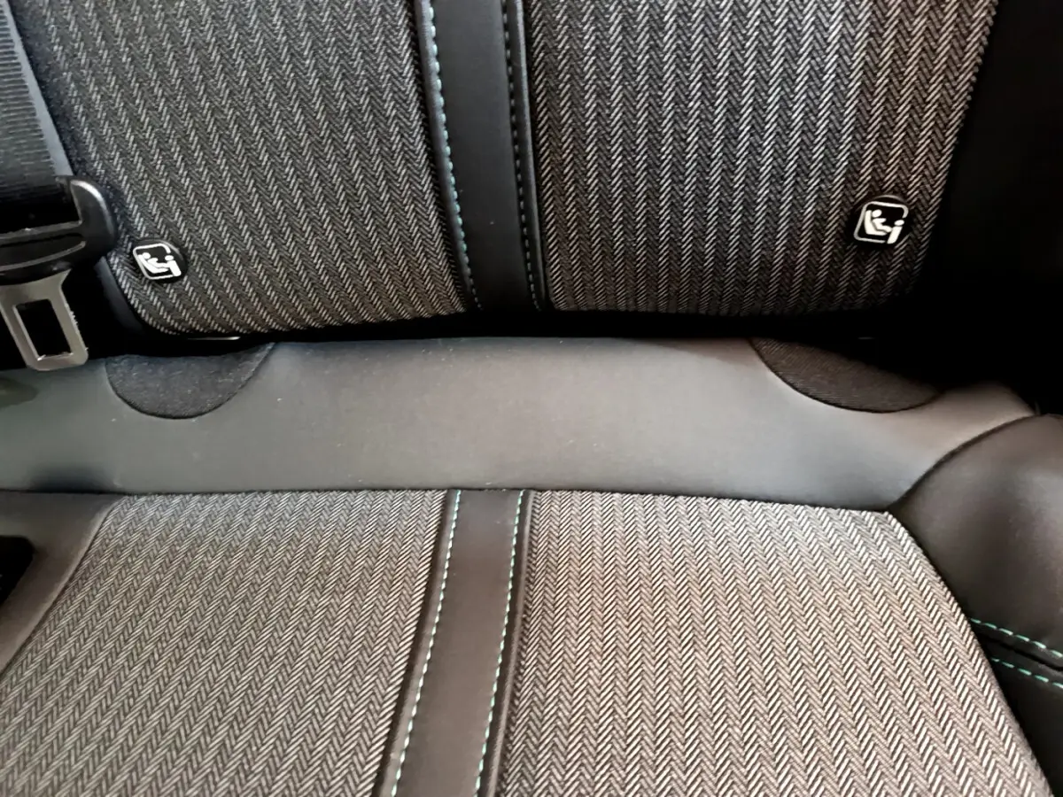 Gros plan sur la banquette arrière du Peugeot 3008 noir 2022, tissu à chevrons avec logos Isofix visibles.