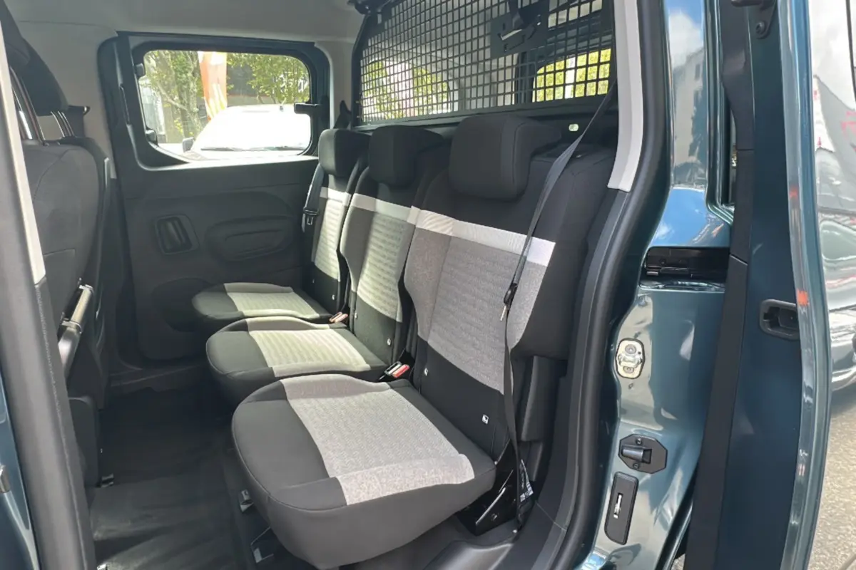 Vue intérieure côté droit du Citroën Berlingo 2025 Kiama blue, montrant les sièges arrière et la grille de séparation.