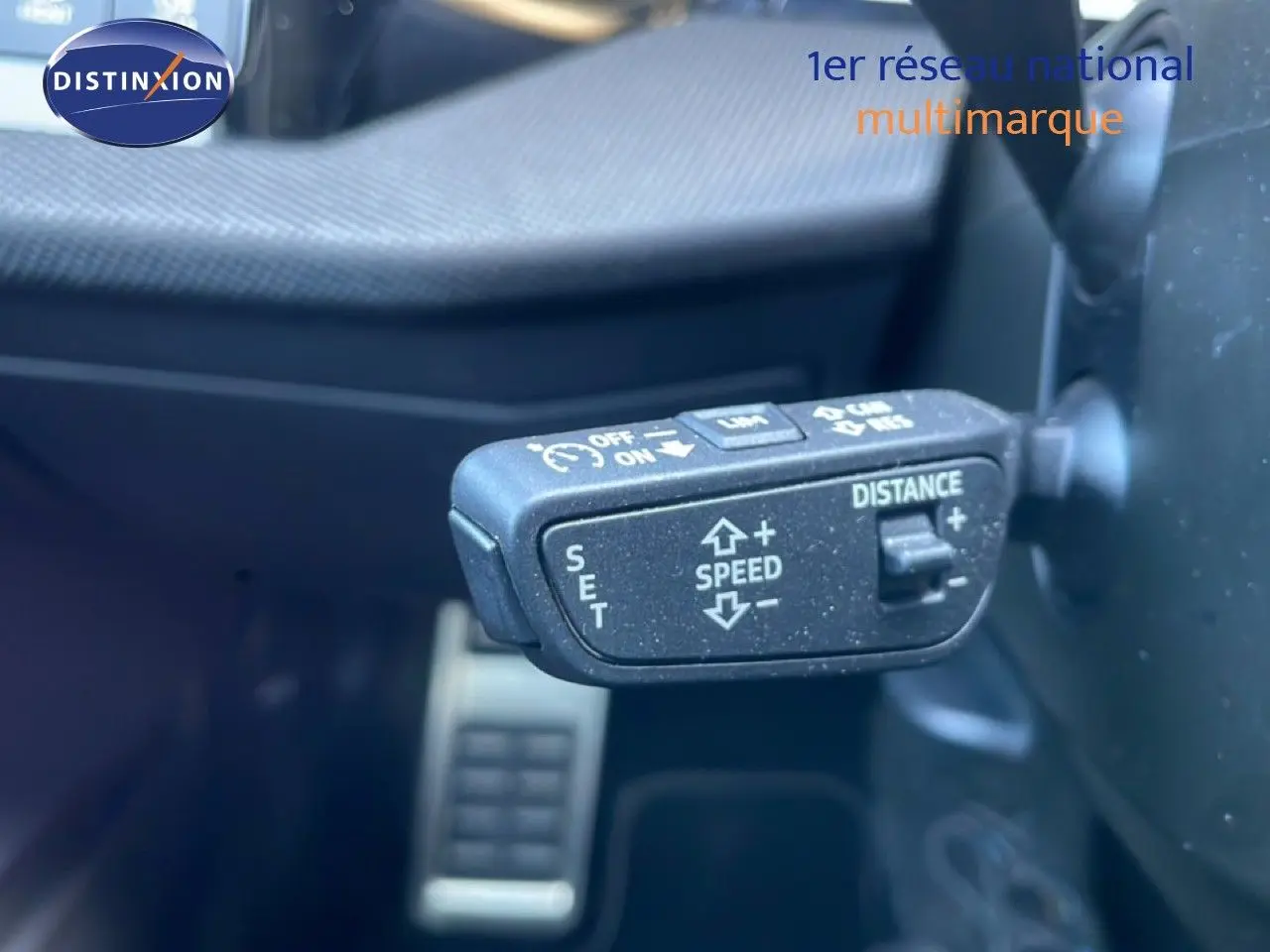 Gros plan sur la commande de régulateur de vitesse adaptatif à gauche du volant dans l’Audi A3 Sportback noir Mito Metal 2025.