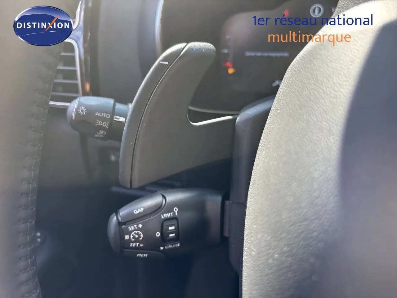 Gros plan sur la commande de régulateur de vitesse et palette de changement sur le volant d’un Citroën C5 Aircross noir.
