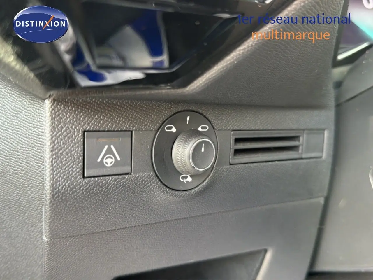 Gros plan sur les commandes de réglage des phares et l’assistance au maintien de voie dans l’habitacle noir du DS7 2024.