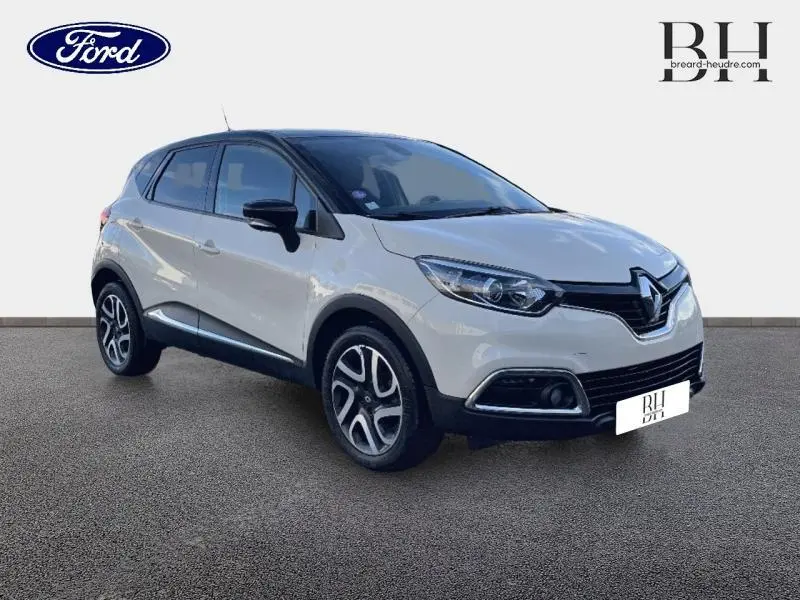 Renault Captur beige cendré vue 3/4 avant droit avec toit noir étoilé et jantes alu distinctives.