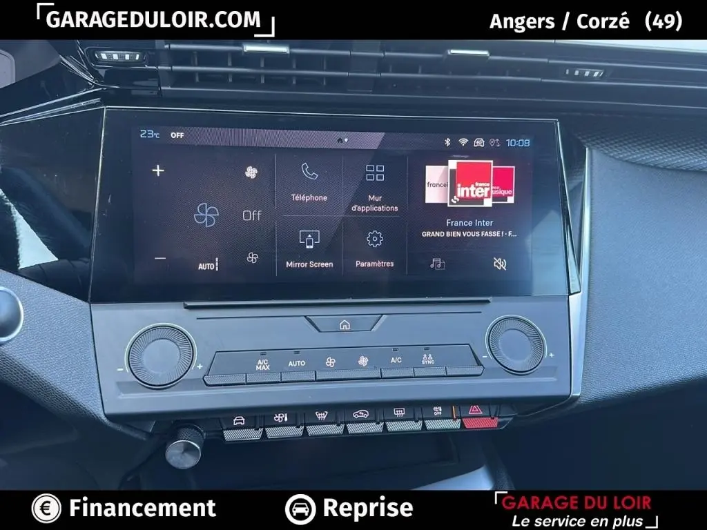 Vue rapprochée de l’écran tactile central et des commandes de climatisation de la Peugeot 308 gris clair 2023.