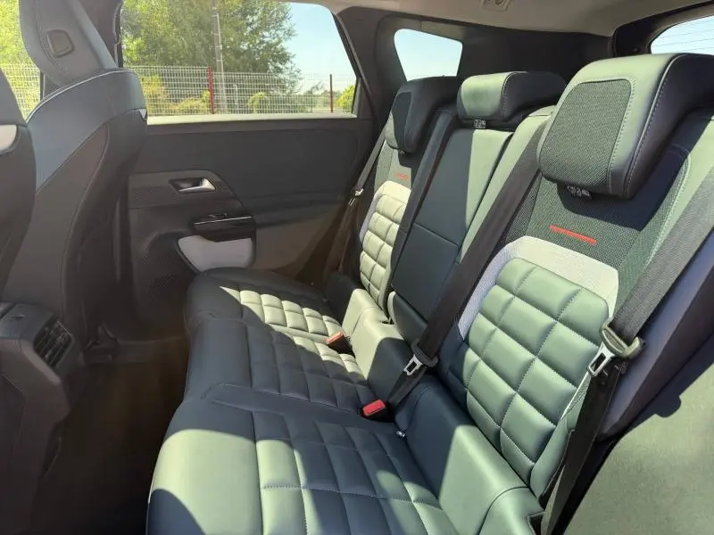 Vue intérieure côté droit des sièges arrière du Citroën C5 Aircross 2026 en cuir noir avec surpiqûres et accoudoir central.