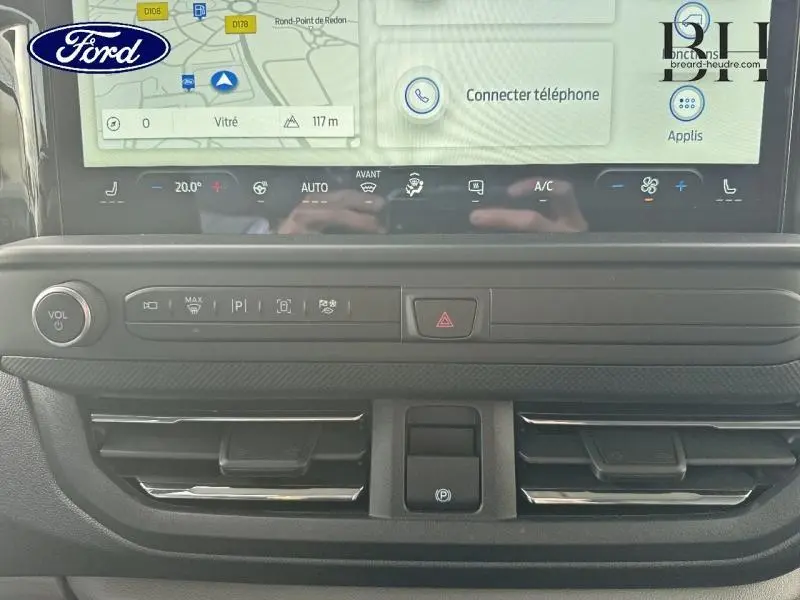 Vue rapprochée du tableau de bord du Ford Transit Custom gris lunaire, avec écran tactile et commandes climatisation.