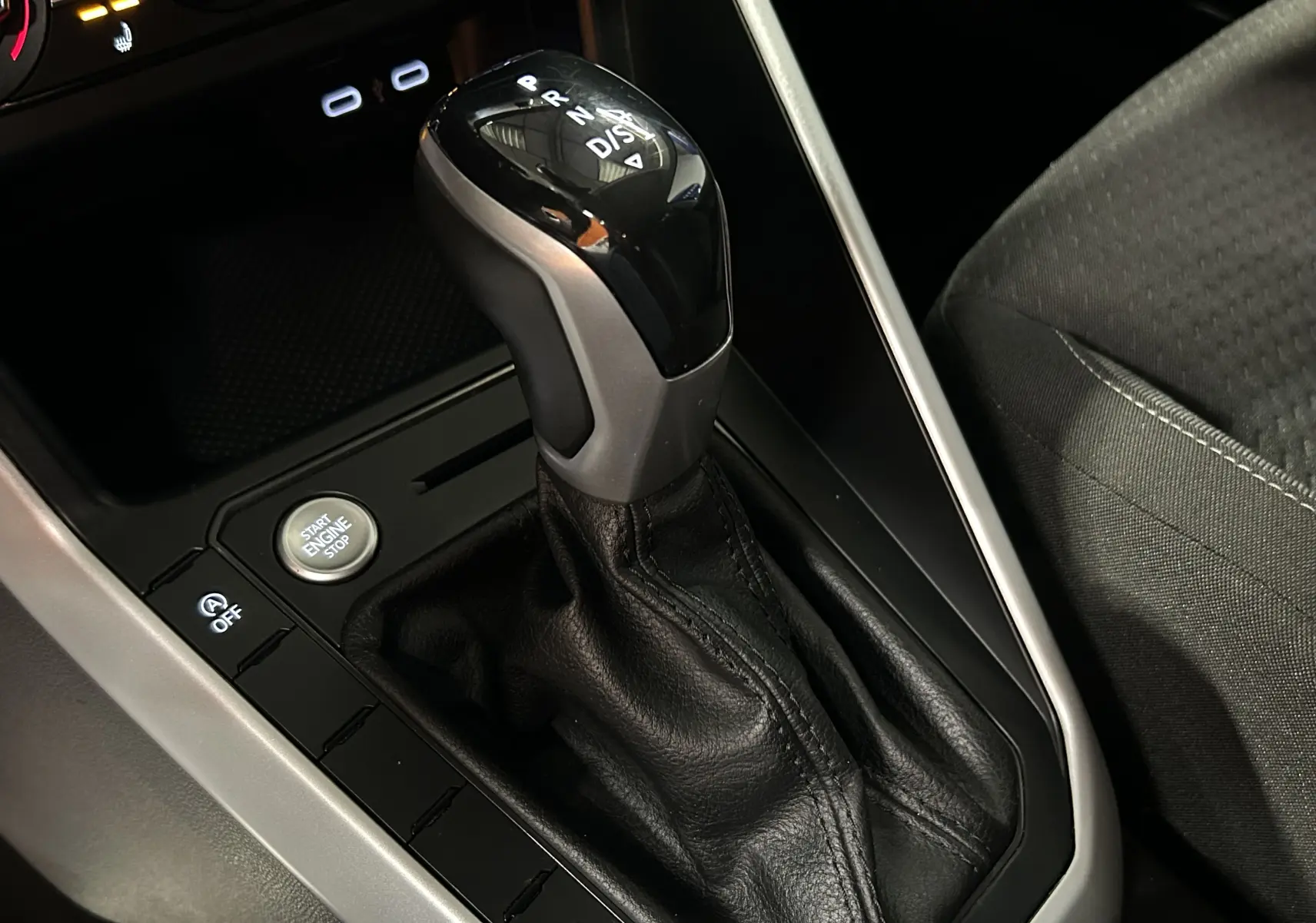 Gros plan sur le levier de vitesses automatique noir et argenté de la Volkswagen Polo 2022, avec bouton Start Engine visible.