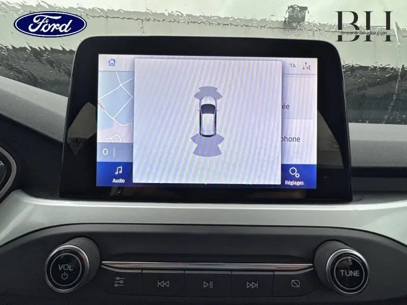 Écran tactile central de la Ford Focus SW blanc Glacier 2020 montrant l'interface d'aide au stationnement.
