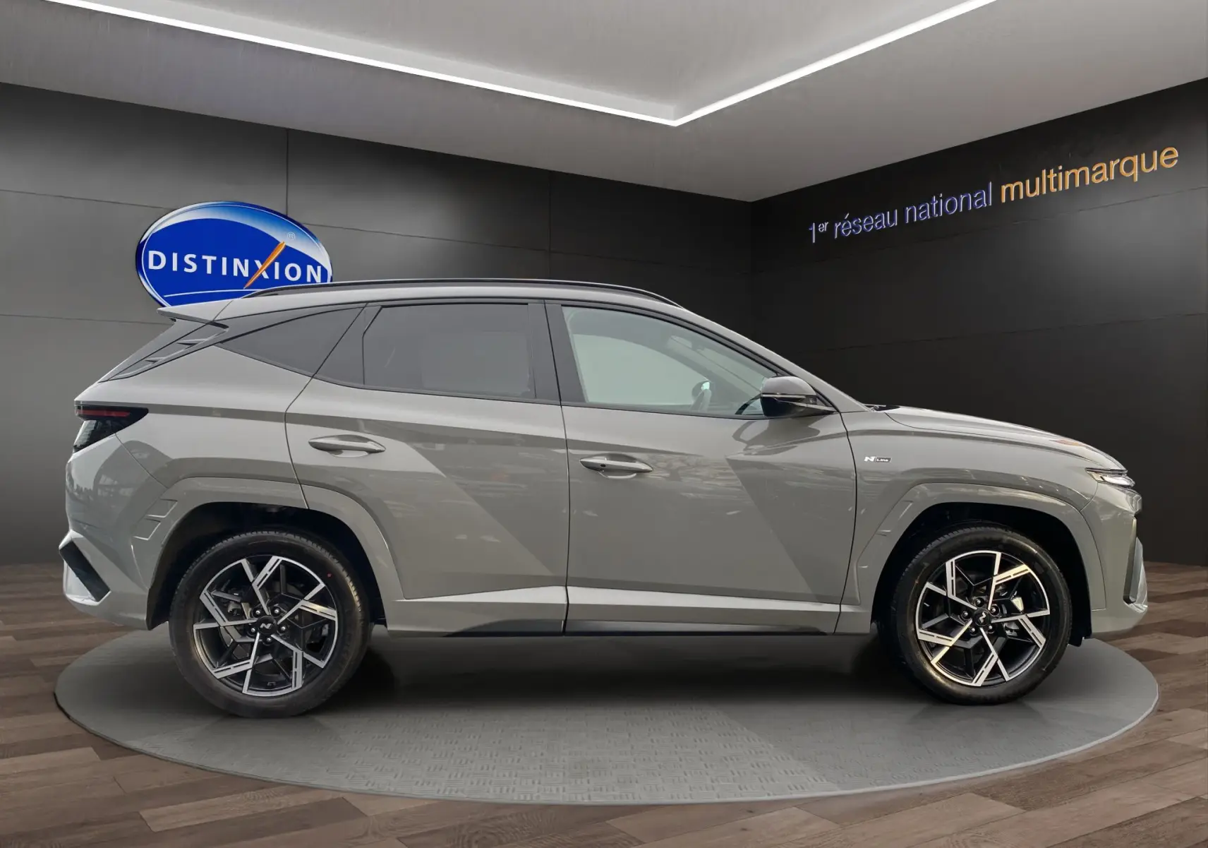 Vue de profil côté gauche du Hyundai Tucson 2026 gris Shadow avec jantes alliage 19 pouces et vitres surteintées.