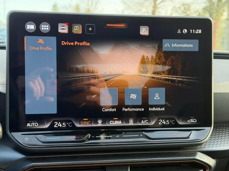 Écran tactile central du tableau de bord de la SEAT LEON 2025 affichant les modes de conduite et la climatisation.