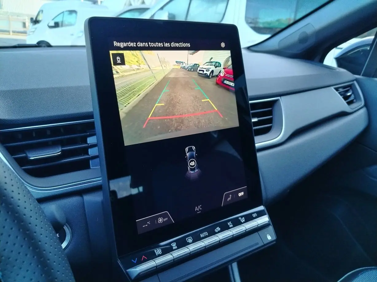 Écran tactile central affichant la caméra de recul dans l'habitacle gris du Renault Captur E-Tech 2025.