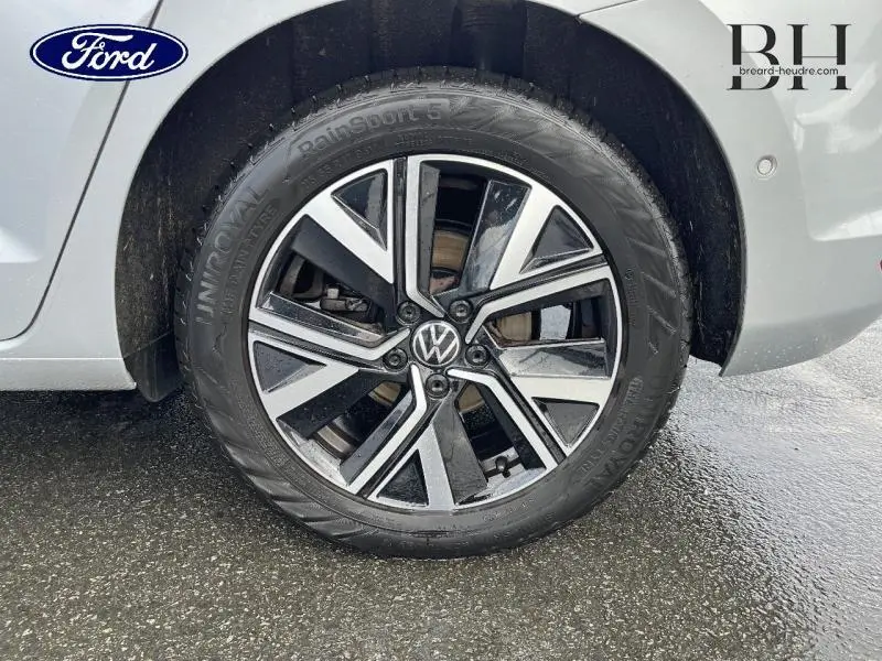 Gros plan sur la roue arrière droite d'un Volkswagen Touran 2021 en Reflet d'Argent Métallisée avec jante alliage bicolore.