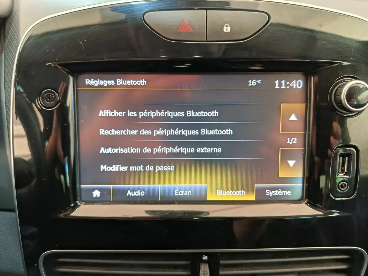 Écran tactile central de la Renault Clio Intens 2018 affichant les réglages Bluetooth, entouré de commandes noires brillantes.