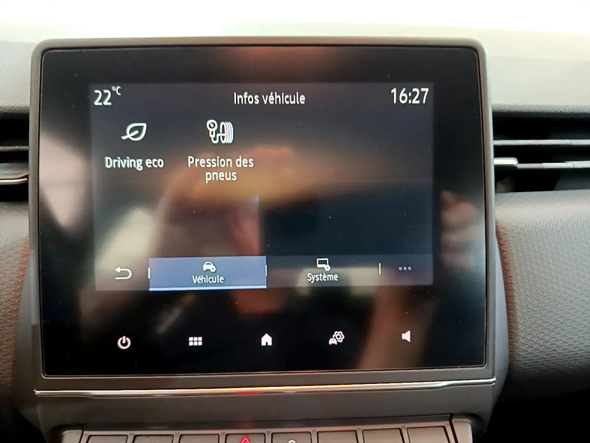 Écran tactile central affichant les infos véhicule d'une Renault Clio Business blanche, vue intérieure frontale.