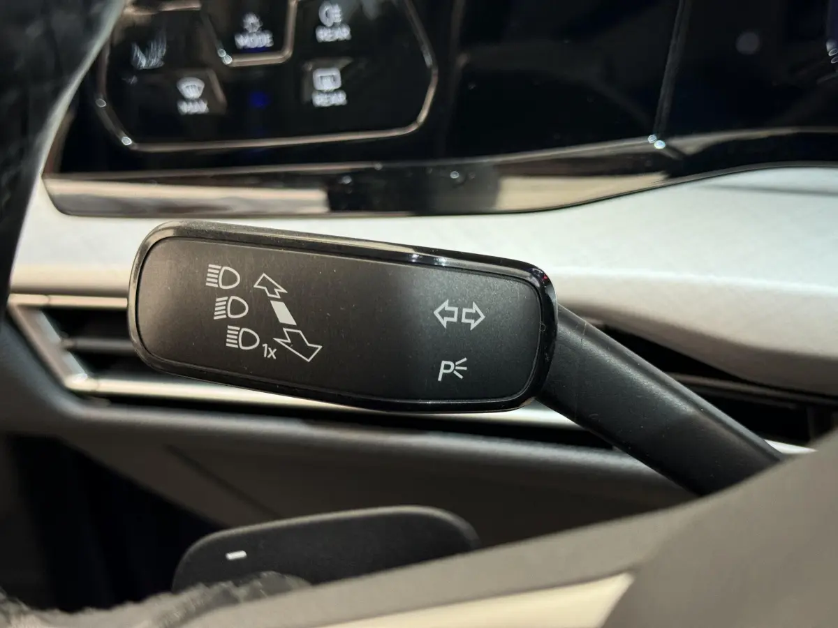 Gros plan sur la commande de clignotants noire dans l'habitacle clair d'une Volkswagen Golf 2.0 TDI bleu 2021.