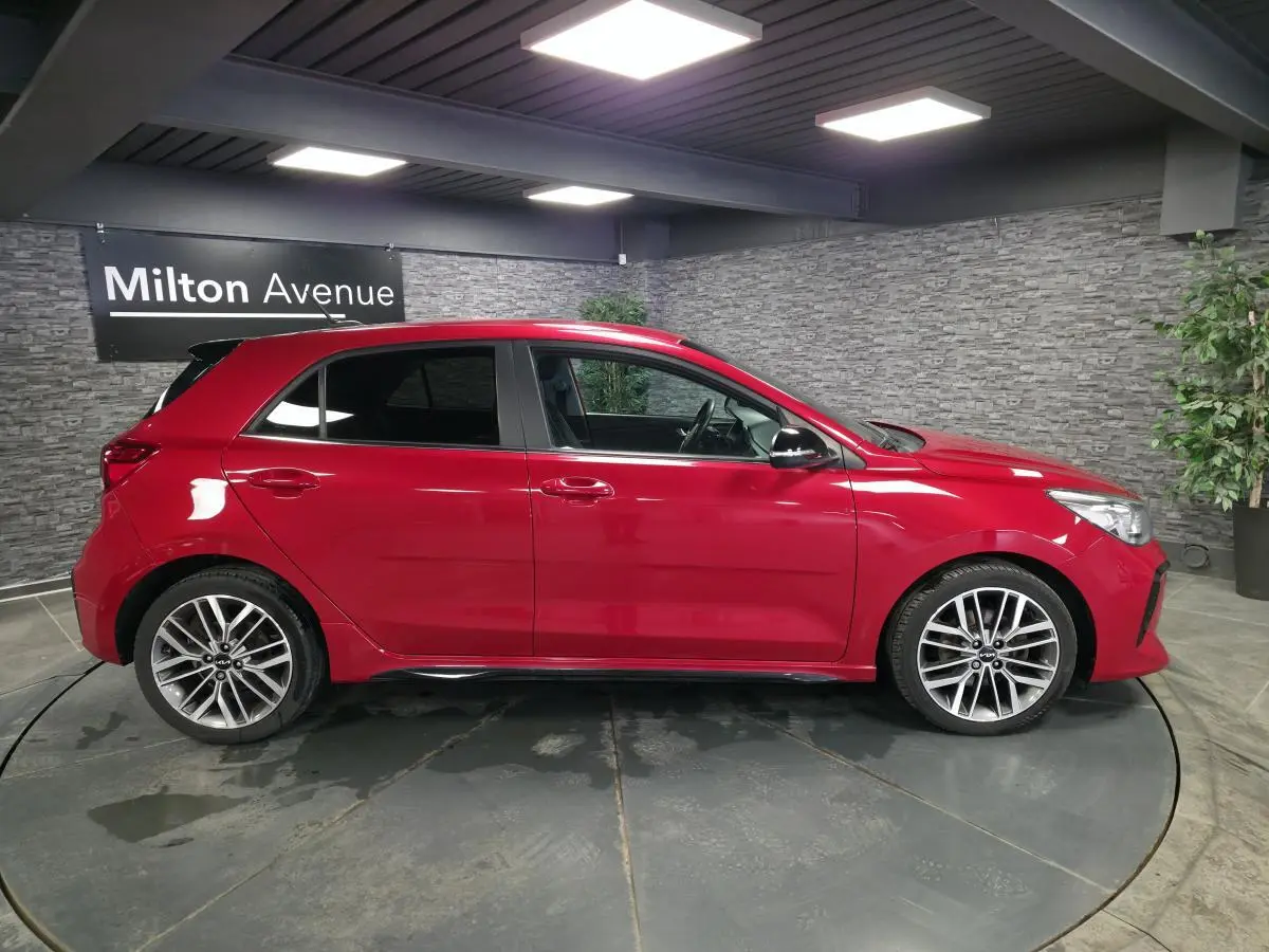 KIA Rio GT Line rouge vue de profil côté gauche, avec jantes alliage 17'' et rétroviseurs noirs métallisés.
