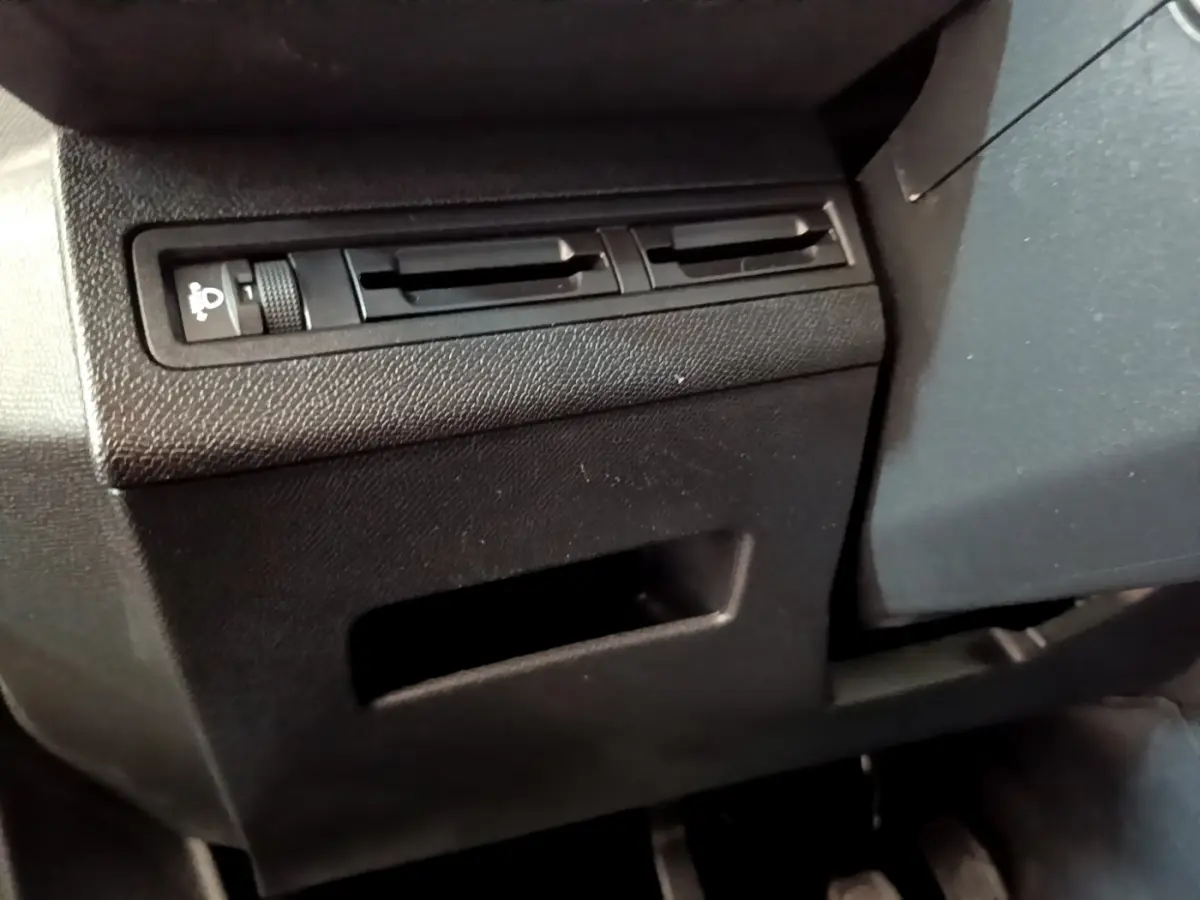 Détail du tableau de bord côté gauche du Peugeot 3008 noir, montrant la commande de réglage des phares et les aérateurs.