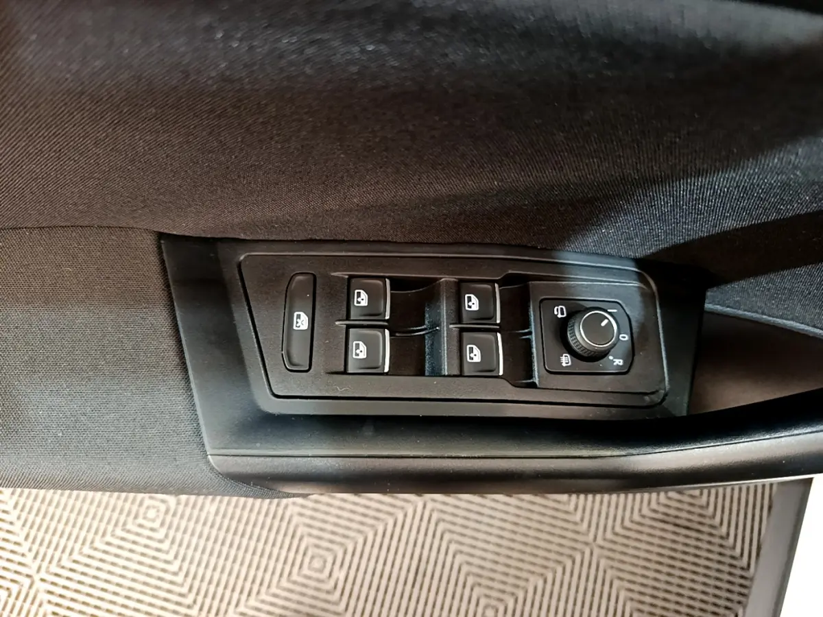Commande des vitres et réglage des rétroviseurs sur la porte côté gauche d'un Volkswagen T-Roc blanc 2021.