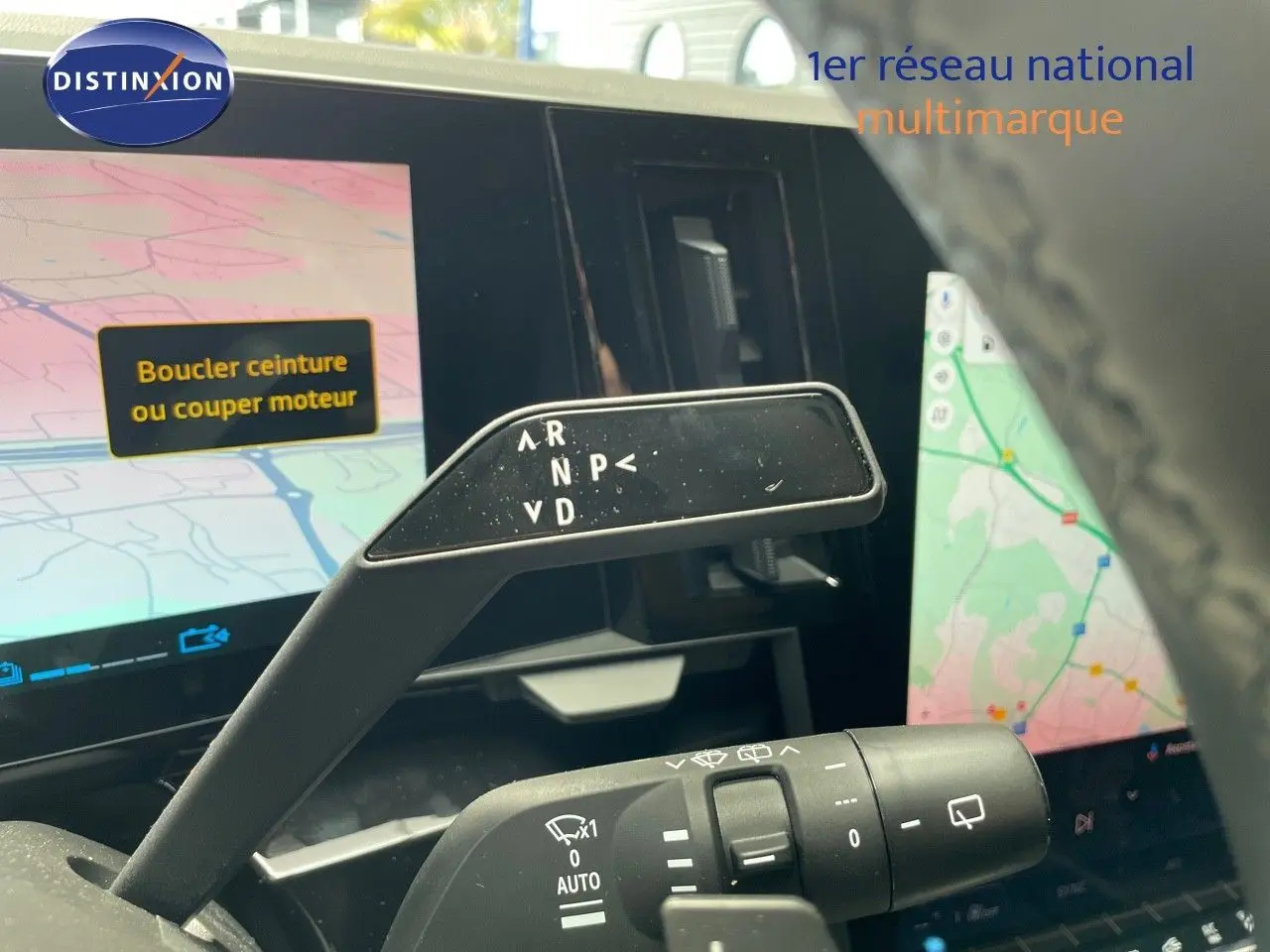 Le levier de boîte automatique du Renault Austral E-Tech rouge passion, vu de près avec l'écran tactile en arrière-plan.