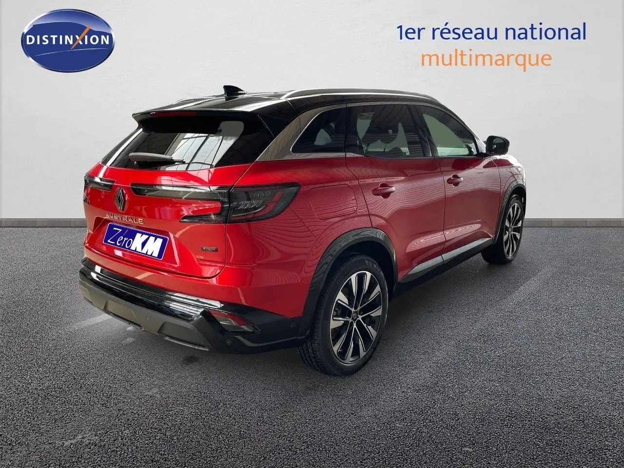 Vue 3/4 arrière droite d'un Renault Austral rouge passion avec toit noir, jantes alliage et feux arrière LED.