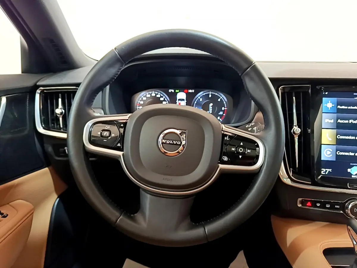 Vue frontale du volant noir en cuir du Volvo V90 Cross Country 2019 avec tableau de bord digital et écran tactile latéral.