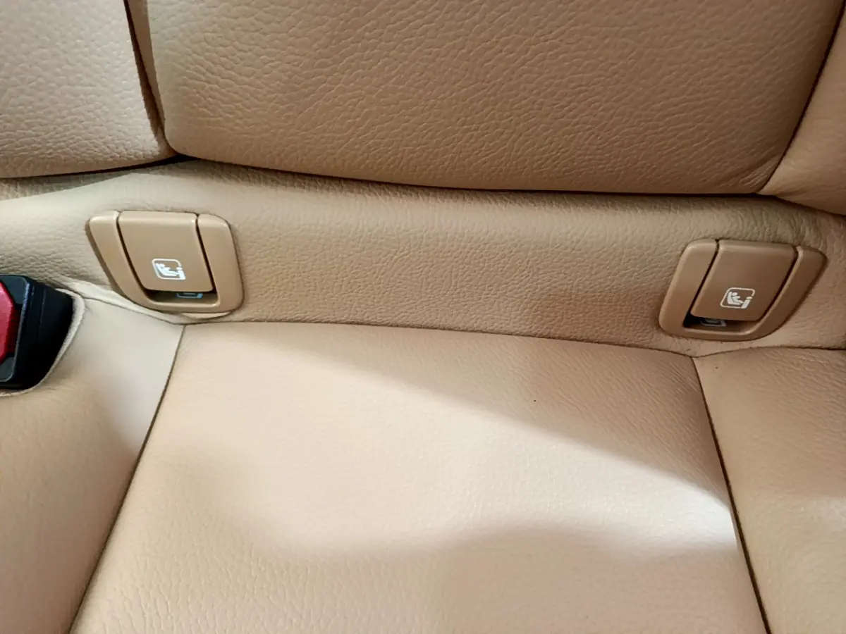 Détail des commandes Isofix sur la banquette arrière en cuir beige du Volvo V90 Cross Country 2019.