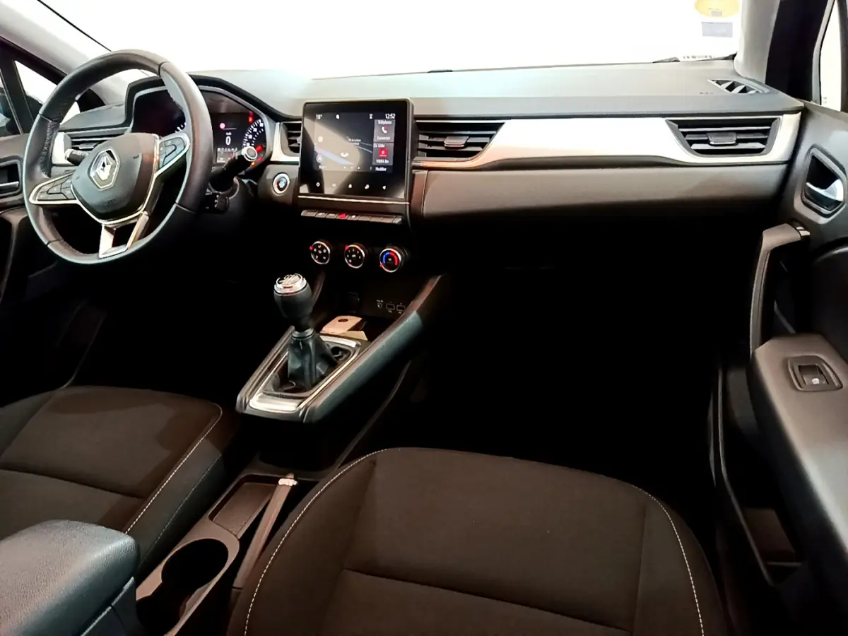 Vue intérieure côté conducteur du tableau de bord noir du Renault Captur Business Blue dCi 95 avec écran tactile central.