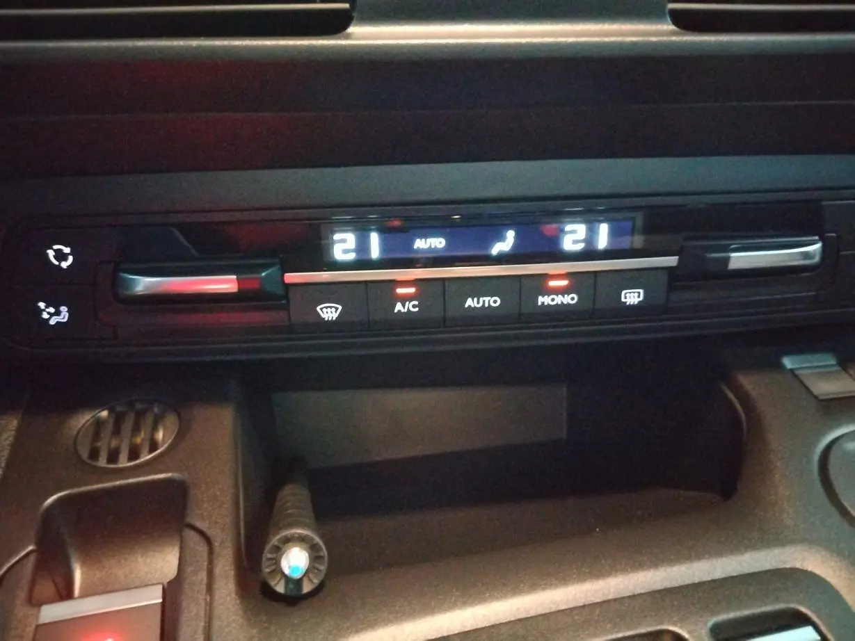 Détail du tableau de bord du Citroën Berlingo 2025 montrant la commande de climatisation digitale avec affichage des températures à 21°C.