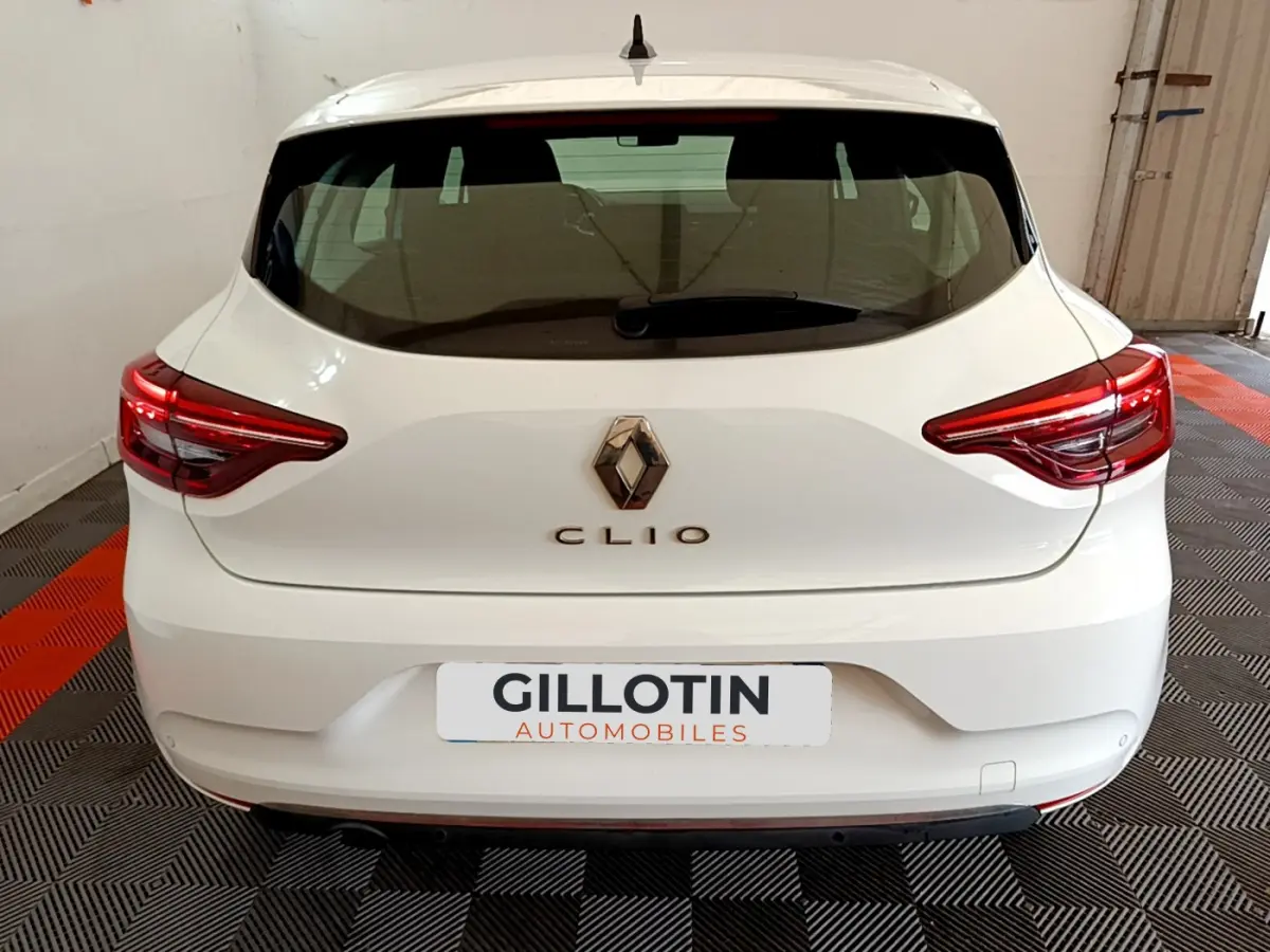 Vue arrière d'une Renault Clio blanche de 2020, avec feux arrière LED et logo Renault bien visible.
