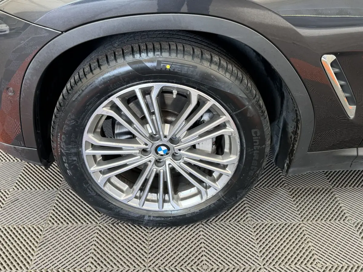 Gros plan sur la roue avant droite gris foncé d'un BMW X3 xDrive30d 2018 avec jante alliage multi-branches.